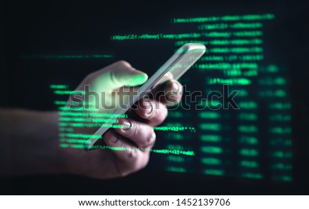 Darkweb, darknet and hacking concept. Hacker with cellphone. Man using dark web with smartphone. Mobile phone fraud, online scam and cyber security threat. Scammer using stolen cell. AR data code.