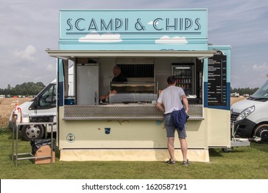 Darlington / Great Britain - August 3, 2019 : Male Customer At A Fish And Chips Vendor Stall Outside Buying Hot Food