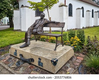 Darlowo, Poland - August 18, 2021. Monument of Leopold Tyrmand (Polish novelist, writer, and editor) sitting on a bench unveiled in 2019.