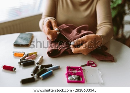 darning an old pullover by hand