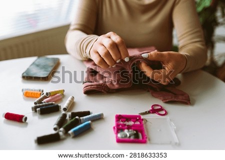 darning an old pullover by hand