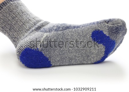 darning socks, repairing holes in socks on white background