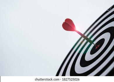 Dart Arrow Hit Dartboard And Goal With Sunlight ,Setup Objectives And Target For Business Investment Concept.