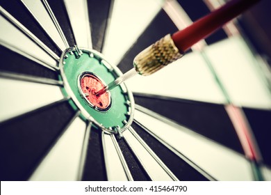 Dart arrow hitting in the target center of dartboard - Shutterstock ID 415464790