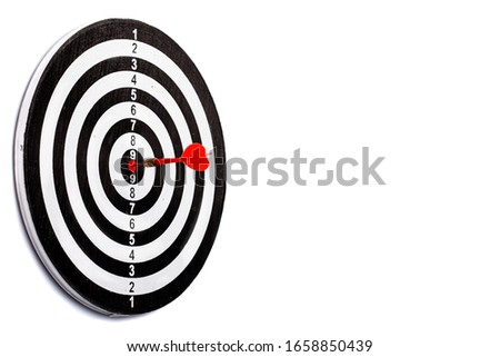 dart arrow hitting in the target center of dartboard. concept of the success