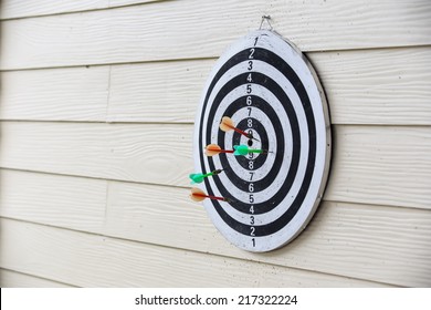  Dart Board Arrows Missed Target On Wood Wall Of Public