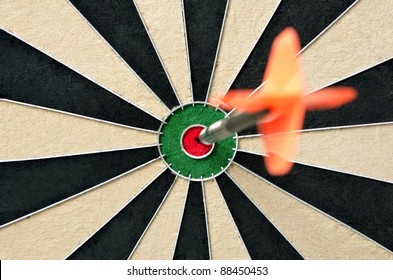Dart in bulls eye of dartboard