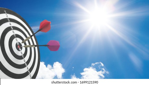 Dart target with an arrow on sky background - Shutterstock ID 1699121590