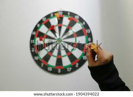 dartboard with numbers and colors and colored arrows