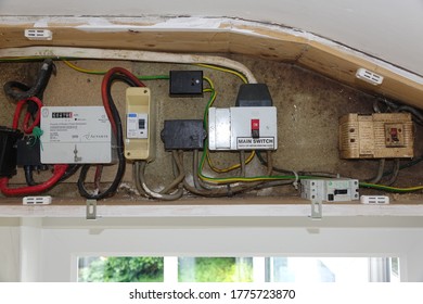 Dartmoor England. Domestic Electric Meter Cupboard With Analogue Electric Meter. RCD Safety Cut Out, Main Switches And Wiring. In Wooden Box On Wall. No Smart Metre.