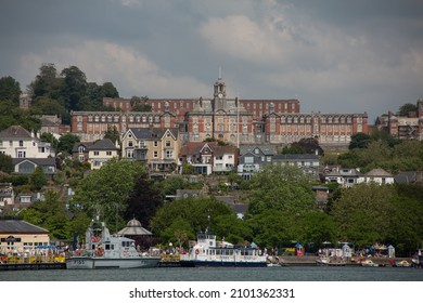 Dartmouth, Devon UK 30 June 2021 : Panorama view of Britannia Royal Naval College BRNC is the naval academy of the UK seen from the harbour with ships on the water