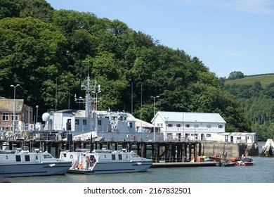 Dartmouth England June 2022. Dockyard with is part of the Britannia Royal naval college on the river dart used for the training of Royal naval officers. 