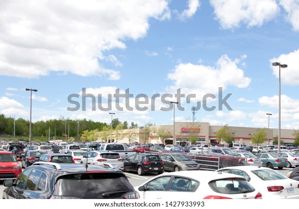 Dartmouth, Nova Scotia, Canada- June 15, 2019: Busy\
parking lot on a Saturday afternoon at Costco Wholesale in\
Dartmouth Crossing 