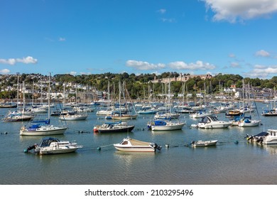 Dartmouth, United Kingdom - September 2021: Ships moored in Dartmouth harbour with Britannia Royal Naval College in the background, Devon, England, United Kingdom
