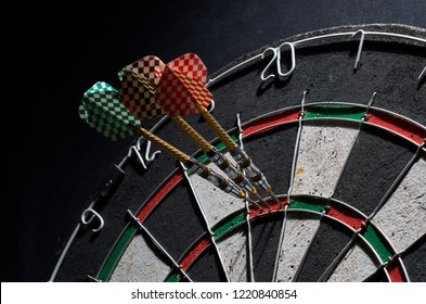 darts. 3 darts in triple 20. Black background - Shutterstock ID 1220840854