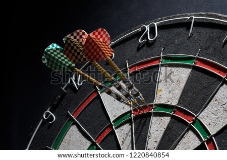 darts. 3 darts in triple 20. Black background