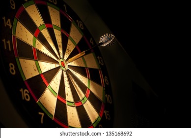 darts arrows in the target center - Shutterstock ID 135168692