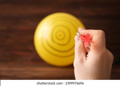 Darts Player Using Balloon As Dartboard, Closeup