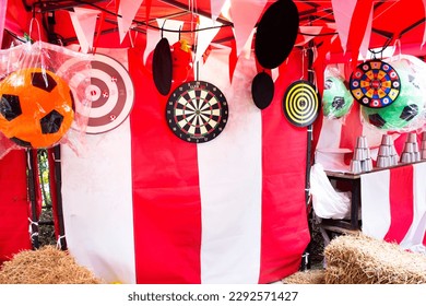 Darts throwing or throwers arrows in dartboard local carnival funfair festival for thai people and foreign travelers travel visit and playing in park garden at rural countryside in Bangkok, Thailand