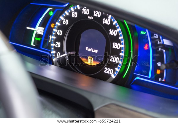Dash board with empty\
Petrol, gasoline gauge in car with digital warning light sign of\
run out of fuel turn on background. Low level of fuel show on\
speedometer dashboard.