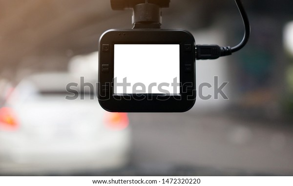 Dash Camera or car camera with white screen\
monitor and blurry\
background.