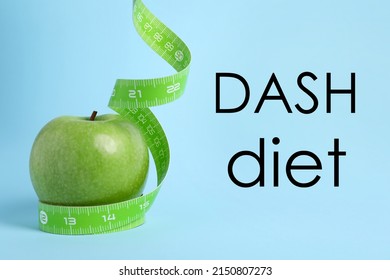 DASH Diet To Stop Hypertension. Ripe Green Apple And Measuring Tape On Light Blue Background