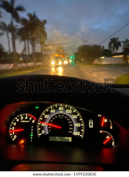 Dashboard of a car commuting to work on a rainy\
day in South Florida.