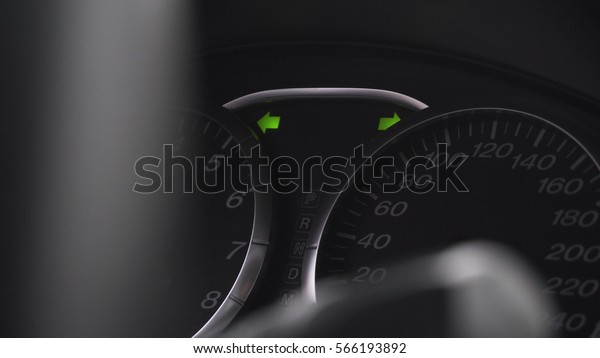 the dashboard of the car. The\
indicator on the dashboard of the car. Green arrow\
turning