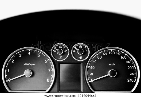 Dashboard\
of a car showing tachometer,  speedometer, temperature gauge and\
fuel guage. Close up on th dashboard in the\
car