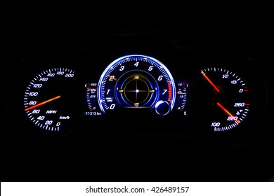 Dashboard and digital display of a modern car, mileage, fuel consumption, speedometer. New and colorful light indicators isolatred on a black background. Closeup. Miles per hour - MPH.