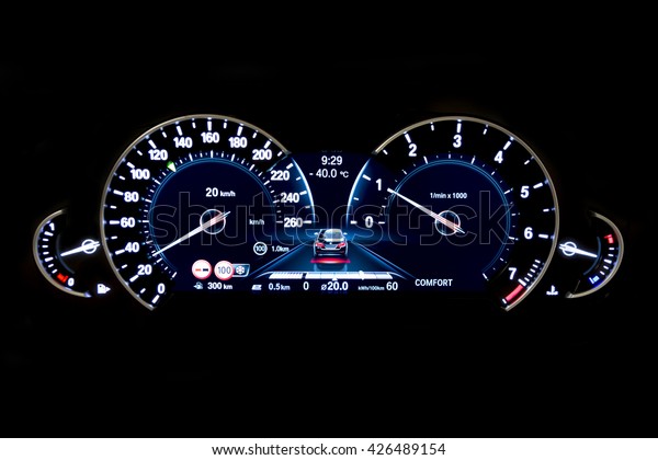 Dashboard\
and digital display of a modern car, mileage, fuel consumption,\
speedometer. New and colorful light indicators isolatred on a black\
background. Closeup. Kilometers per hour -\
KPH.