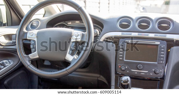 Dashboard of a recent car with steering wheel and\
on-board computer GPS