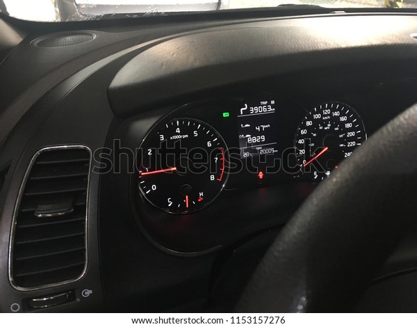 Dashboard of a rental car in a foreign country\
using the metric\
system
