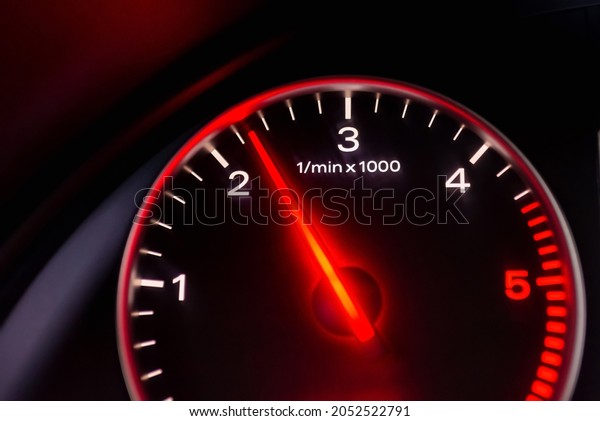 Dashboard with speedometer, tachometer, odometer.\
Car detailing. Car dashboard. Dashboard details with indication\
lamps.Car instrument panel.Modern interior.Close up shot.Blurred\
image.