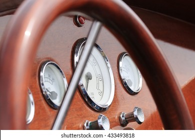 Dashboard And Steering Wheel Of A Classic Wooden Speedboat.