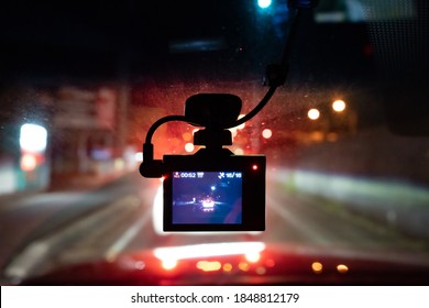 A dashcam is shooting forward in the evening 
