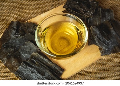 Dashi Or Japanese Soup Stock In The Glass Bowl With Dried Kombu Seaweed On Wooden Tray.