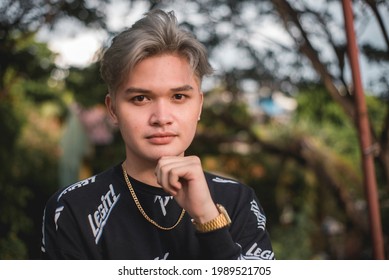 A Dashing Handsome Young Asian Man With Ash Blonde Dyed Hair In A Black Long Sleeve Shirt. Modern Gen Z Guy.