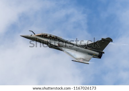 Dassault Rafale flying overhead with vortex over canards and wings in front of clouds at BAF Spotters Day, Air base Kleine Brogel