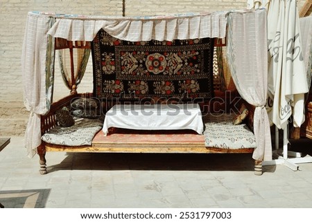 Dastarkhan. Trestle bed with short table with tablecloth used during the meal in the Eastern countries. Khiva street.  Uzbekistan 