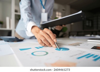 Data Analysis and Presentation. A professional analyzing charts and reports while preparing for a meeting. - Powered by Shutterstock - Get 15% off with code: PIKWIZARD15