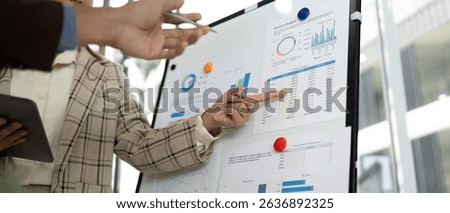 Data Analysis and Presentation. Professional team reviewing business metrics in a modern office.