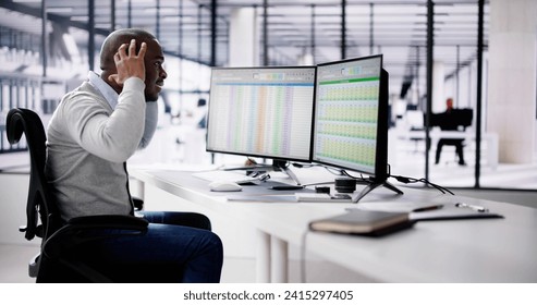 Data Analyst African Man Using Spreadsheet On Computer