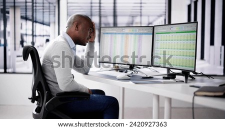 Data Analyst African Man Using Spreadsheet On Computer