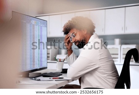 Data Analyst African Man Using Spreadsheet On Computer
