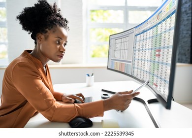 Data Analyst African Woman Using Spreadsheet On Computer - Powered by Shutterstock