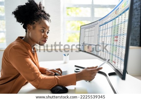 Data Analyst African Woman Using Spreadsheet On Computer