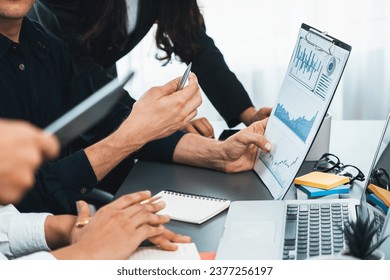 Data analysts team of office worker collaborate on business intelligence BI dashboard to analyze financial, trend, and marketing data. BI software utilization drive business success. Prudent