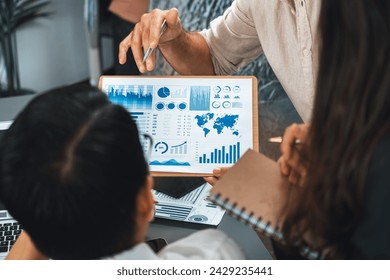Data analysts team of office worker collaborate on business intelligence BI dashboard to analyze financial, trend, and marketing data. BI software utilization drive business success. Prudent