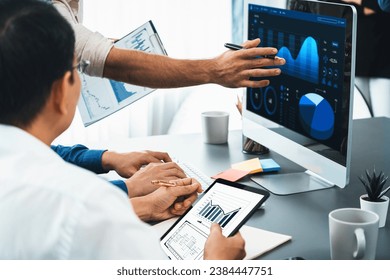Data analysts team working analyzing business intelligence BI dashboard display on laptop to analyze financial, trend, and marketing data. BI technology and data analysis for business success. Prudent